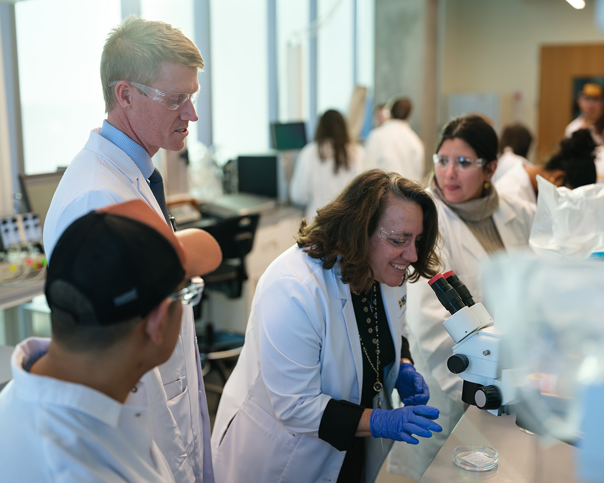David Arnold Lab Group Peering Through a Microscope